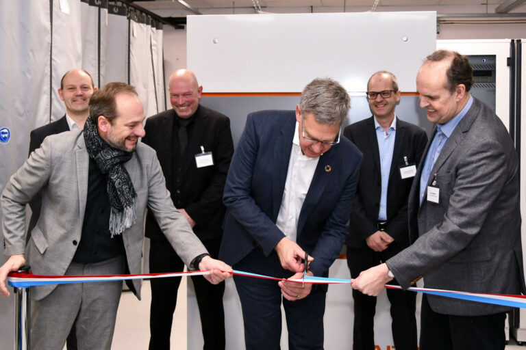 Photograph of RAITH and LIST colleagues at the ribbon cutting ceremony of collaboration on MagSIMS